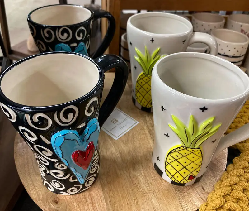 Ceramic mugs with pineapples and hearts are some of the gifts available at The Dutch Plant Farm store.