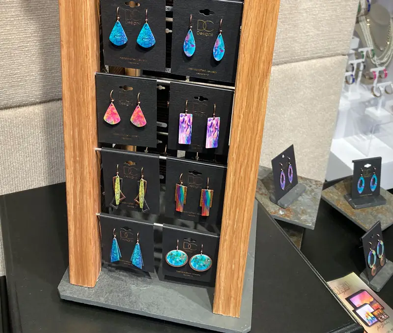 Display of colorful oval, rectangular and triangle-shaped earrings are some of the accessories available at The Dutch Plant Farm store.