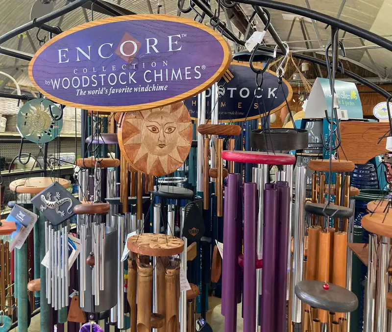 Display of colorful windchimes with metal tubes and wooden strikers | Windchimes are some of the gifts you can find at The Dutch Plant Farm.