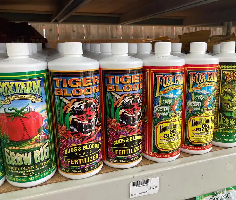 Brightly colored and decorated bottles of natural garden fertilizers are some of the garden supplies available at The Dutch Plant Farm store.