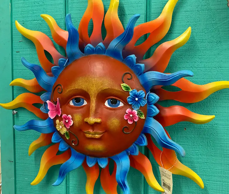 Brightly colored metal sun with rays are some of the fun wall art at The Dutch Plant Farm.