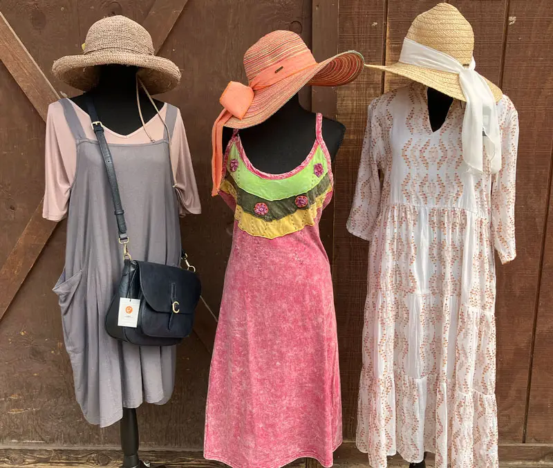 Display of women's summery dresses with matching hats the accessories available at The Dutch Plant Farm store.